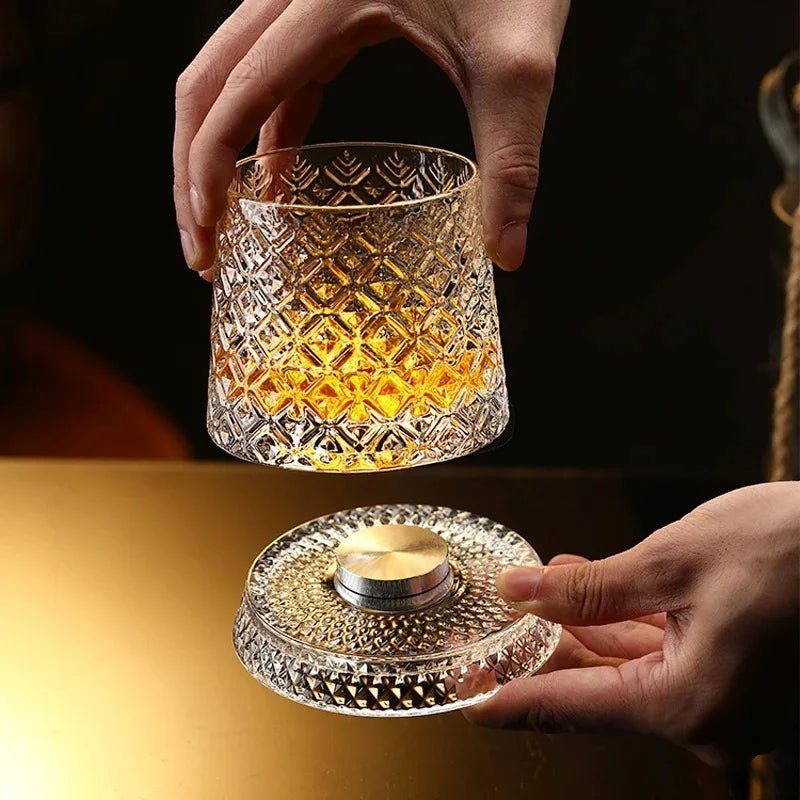 Hands spinning the ArtZ Tokyo Crystal glass on its kinetic base beside a candle